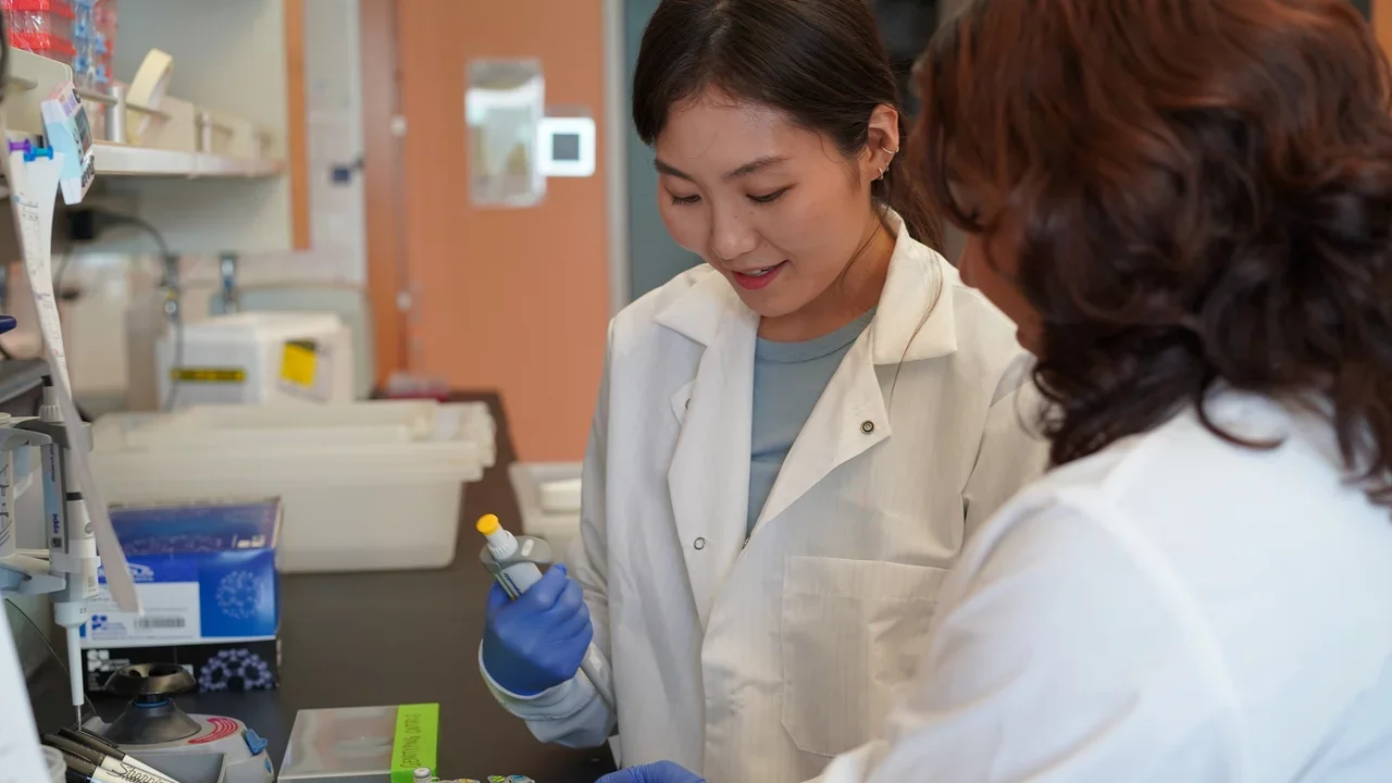 Photo of Lab Manager and Lab Member Working